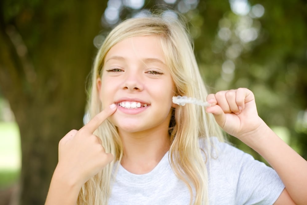 young girl with clear aligner